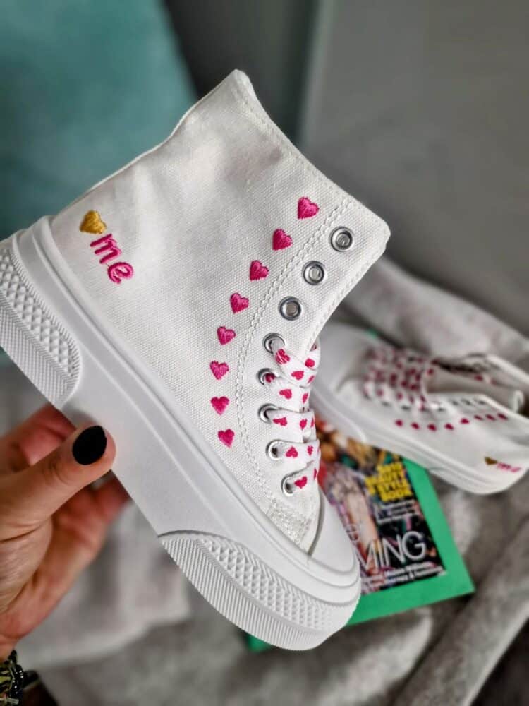 Higher trainers styled with Converse branding, pink hearts